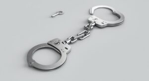 a pair of handcuffs - alcohol use disorder concept image