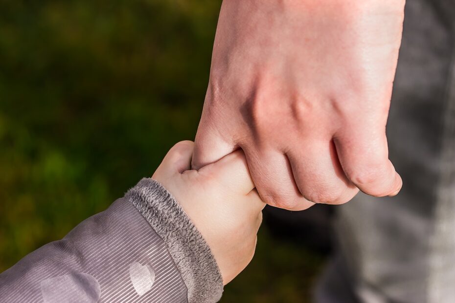 child holding parent's hand - Decrease Addiction Risk conceptual image
