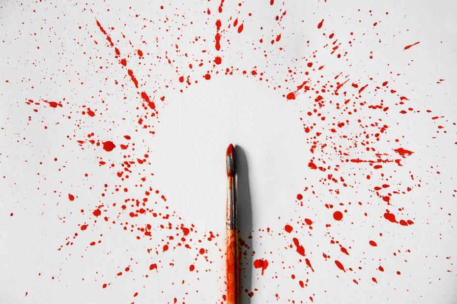 paint brush splattering red paint on an empty canvas - Therapy for Addiction concept image