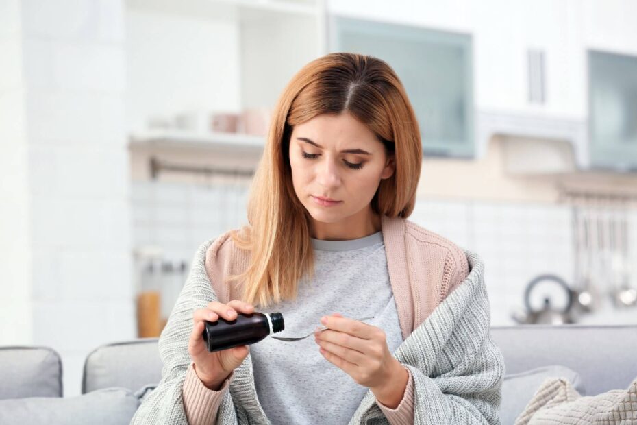 woman taking cough syrup - accidentally using DXM concept image