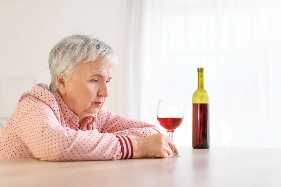 elderly woman drinking alone stressed - elderly addiction